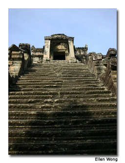 Steep stone stairs lead to a dark, narrow passageway.
