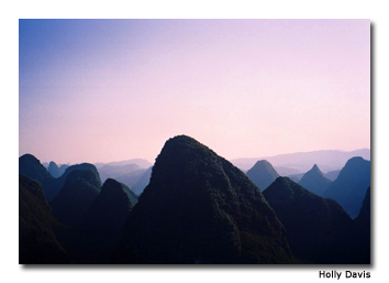 The sharp peaks of the karsts provide a stunning background when viewed from above.