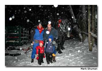 Guests take a break following a nighttime winter sleigh ride.