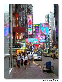 The streets of Causeway Bay are garbed with brightly colored signs.