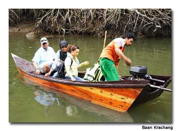 Khun Kii and guests motor through the canal on a fishing trip.