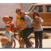 Author (on bike) with her siblings in 1984. The family van in the photo hauled the family of 10 all over the country.