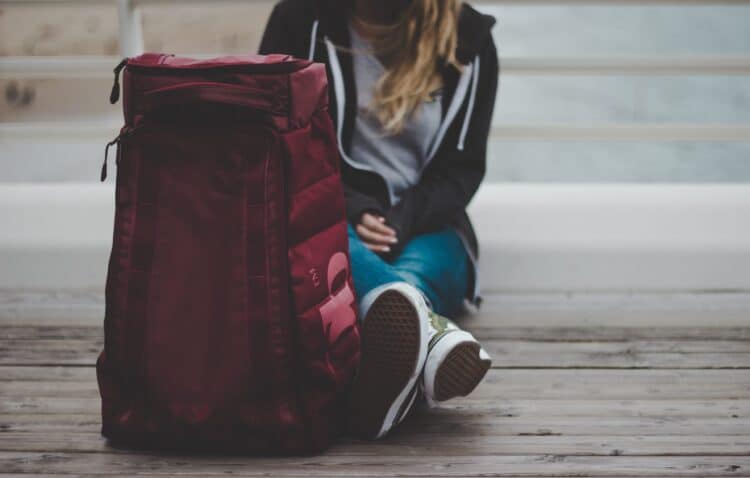 A picture of a woman and a bag. 