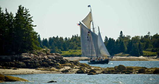 A Maine Windjammer cruises through a narrow passage in Maine.