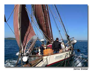 The Angelique drops anchor in a quiet harbor.