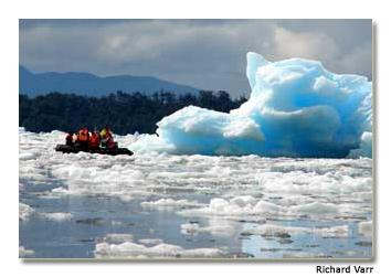 This brilliant blue iceberg is almost close enough to touch from the nearby raft.