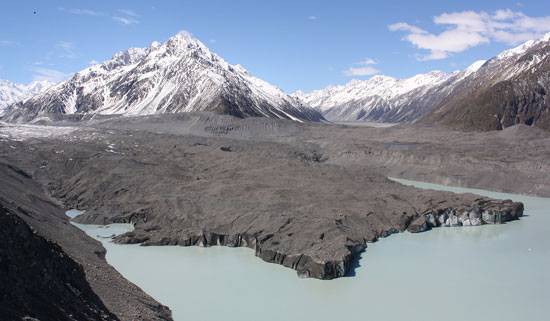 Tasman Glacier Terminal Lake from atop a mountain, with blackened glacial tongue. Photo by Richard Varr. 