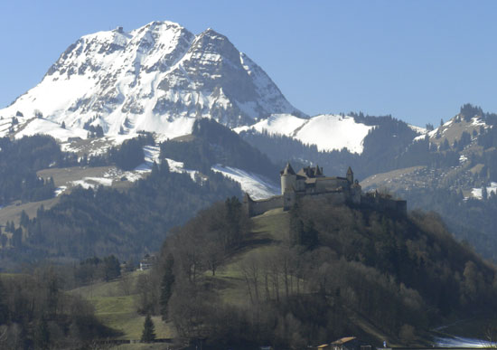 The castle and village of Gruyeres, Switzerland sits high on a hill overlooking the valley. 
