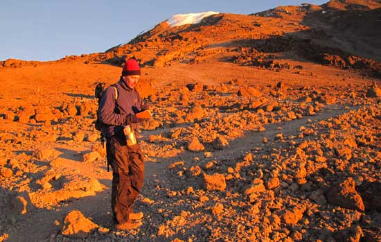 Andrew McCarthy taking notes on Mount Kilimanjaro