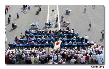 At mass, stretchers pull up in front of wheelchairs.