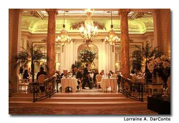 Intricate chandeliers and linen-draped tables set a mood of elegance in the Ritz tea room