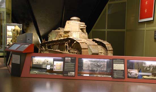 damaged war machine, officially known as a Renault FT-17 tank and commonly used by American forces during World War I, rests in retirement on a museum floor, still nursing its permanent wound in the shape of a gaping hole.