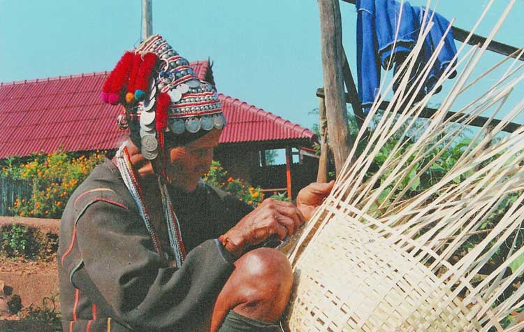 Akha woman weaving a basket in Thailand