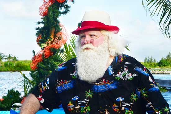 Caribbean Santa greets guests on an island in Camana Bay. Photo credit: Camana Bay