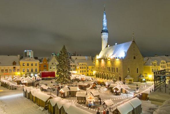 Snow covers the twinkling lights of this Christmas market in Estonia.