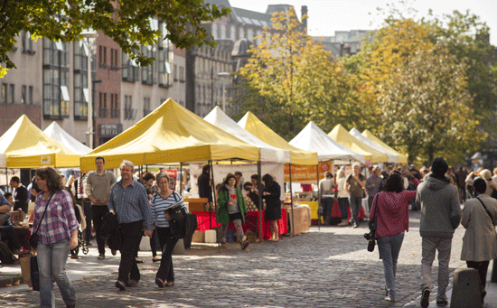 A busy market day at the sunny Grassmarket in Edinburgh.