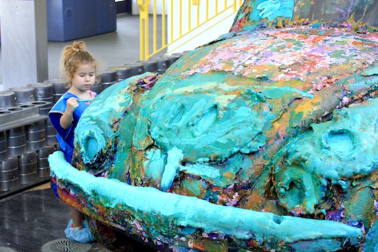 Victoria Desantis, 4, concentrates on painting a VW Beetle set up just for that  purpose at the Children’s Discovery Museum in Palm Springs. Photo by Rick DuVal