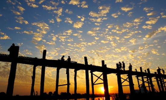 Pedestrians make their way across the U Bein Bridge near the City of Mandalay. At 1.2 km, it's the longest teak bridge in the world. Photo by Pamela Roth