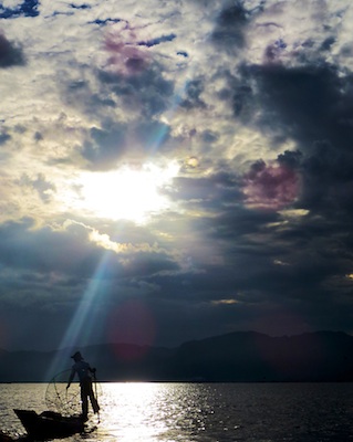 A fisherman tends to his boat on Inle Lake in central Myanmar. Photo by Pamela Roth