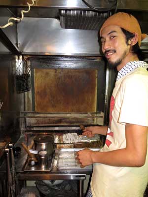 Nosuke Kurihara mans the grill, often feeling like he too is being cooked in the sweltering, smoke-filled kitchen. 