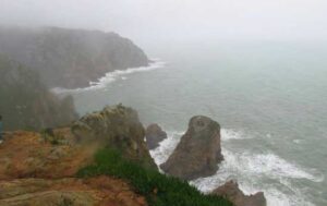 Waves crashing into the Cabo Da Roca cliffs, breaking the stillness of the ocean. Photo by Monica Gray