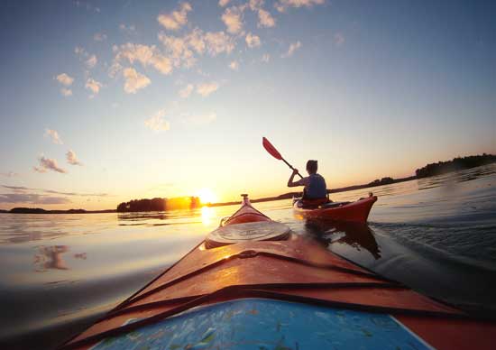 A sunset kayak trip in the Lakeland region, which occupies most of central and eastern Finland. Photo courtesy Visit Finland