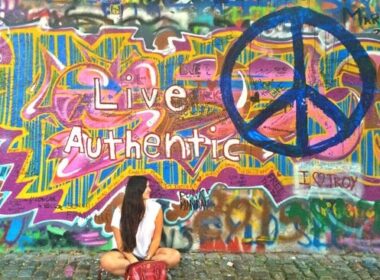 Taking a cliché picture in front of the John Lennon wall in Prague. Photo courtesy Paula Naoufal