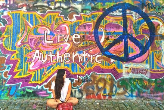 Taking a cliché picture in front of the John Lennon wall in Prague. Photo courtesy Paula Naoufal