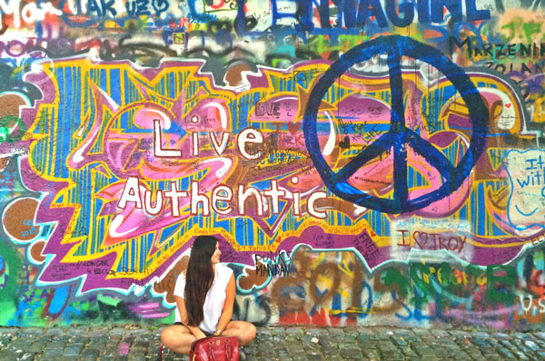 Taking a cliché picture in front of the John Lennon wall in Prague. Photo courtesy Paula Naoufal 