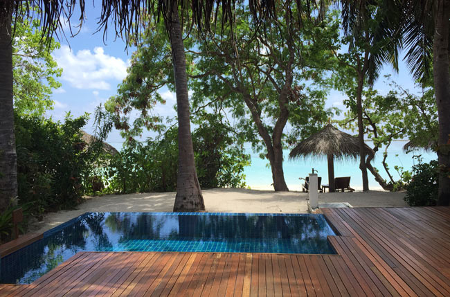 The private deck behind the author's villa at Baros, with plunge pool and beach access. Photo by Janna Graber