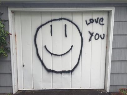 Neil told me on the phone that I would know I was at the correct house because there would be a large smiley face painted on the garage door. 