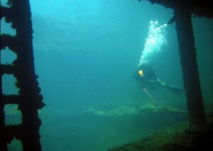Diver in the hold of the Sankisan Maru, a freighter that once carried aircraft. Flickr/Matt Kieffer