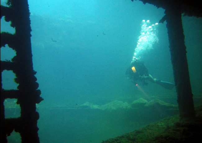 Diving Chuuk - Diver in the hold of the Sankisan Maru, a freighter that once carried aircraft. Flickr/Matt Kieffer