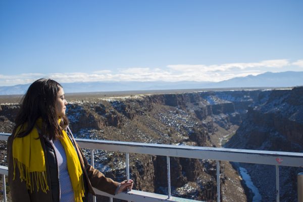 Gabriela Rodriguez holds onto the railing as she looks out over the Rio Grande Gorge.