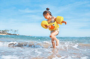 Girl playing on the beach. Photo by Leo Rivas on Unsplash