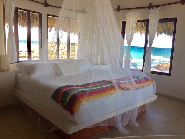 All beds have netting; windows are the only thing between you and the ocean. Photo by Claudia Carbone