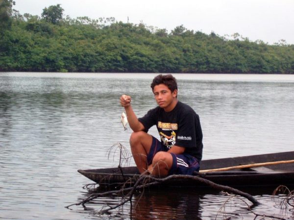 Travel in the Amazon. Railson fishing for piranha. Photo by Victor Block Amazon