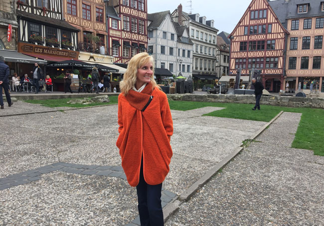 Exploring Rouen, France, and wearing the French coat I purchased in Honfleur. Photo courtesy Janna Graber