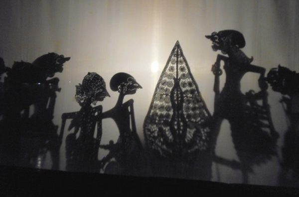 The shadow puppets behind the opaque screen entertain the viewing audience. Photo by Carol L. Bowman