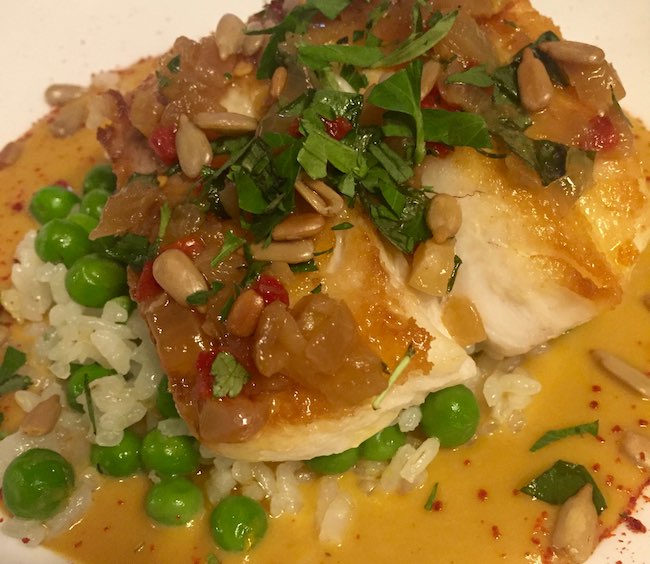 Grilled Red Snapper with Calasparra Rice, Sweet Peas, Cracked Almonds and Orange-Saffron Soubise. Photo by Claudia Carbone 