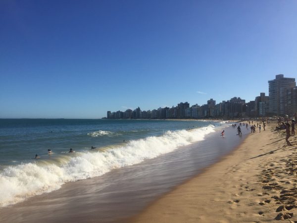 Locals play in the surf along a beach called Praia da Costa. Photo by Mark Blank