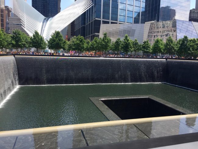 9/11 The Memorial Pool outlining the footprint of the North Tower. The new Oculus building is in the background. Photo by Claudia Carbone
