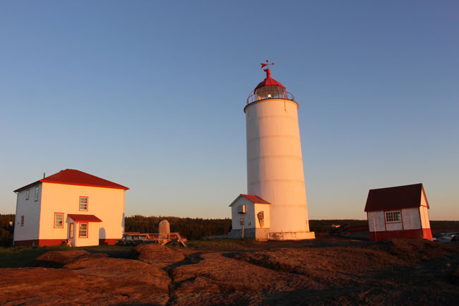 The sun begins to set on the lighthouse, which is now a B&B, on Ile Verte. Photo by Janna Graber