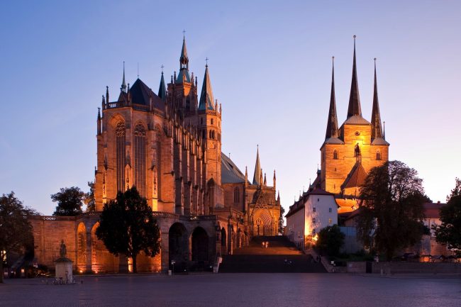 Two magnificent Catholic churches stand on a hill overlooking the central square in Erfurt. The one on the left is St. Mary’s Cathedral and is the place where Martin Luther was ordained. The three-towered structure on the right is St. Severus Church. (Photo credit: Toma Babovic — Thüringer Tourismus GmbH)