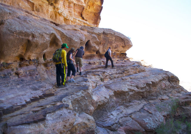 Petra A trail skirts around a wall of rock. Photo by Christine Loomis