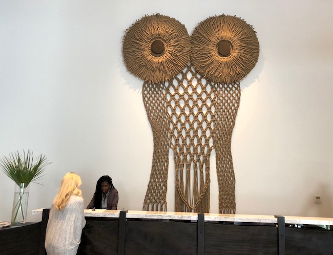 Macramé owl above the front desk. Photo by Claudia Carbone