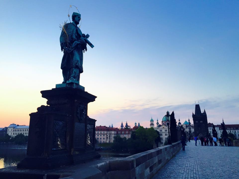 St. John of Nepomuk statue on Prague's Charles Bridge. If you touch certain parts of the statue, it is said to bring good luck and a safe return to the city. Photo by Morgan Statt