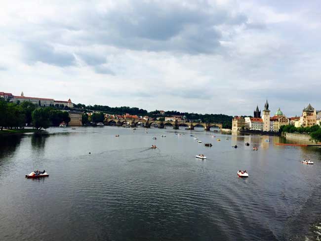 View of the Charles Bridge in Prague during mid-spring. This time of year brings warmer weather and the opportunity to paddleboat on the Vltava River. 