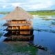 A hut protrudes above the water in Iquitos, Peru. Photo by Tony Mangia