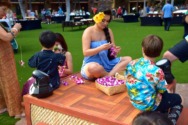 Keiko are shown how to make leis at the Ka Wa’a Luau at the Aulani, A Disney Resort and Spa